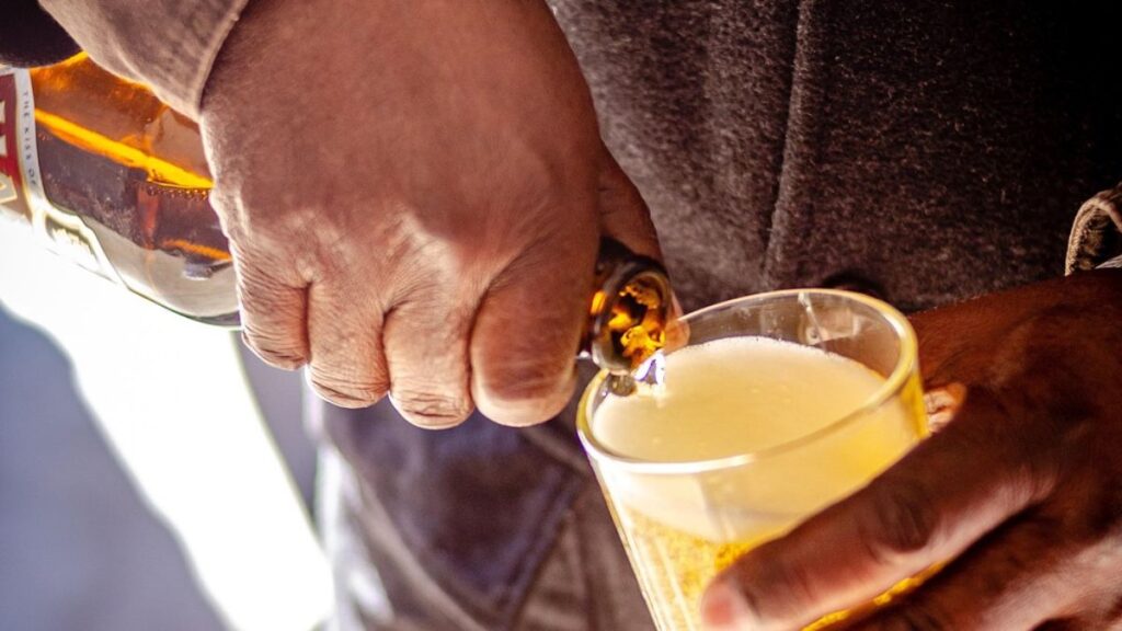 Understanding Dual Diagnosis: Treating Addiction and Mental Health Disorders Simultaneously 2 A man’s hand, dressed in a plaid suit sleeve, pours hard liquor into a glass jigger.