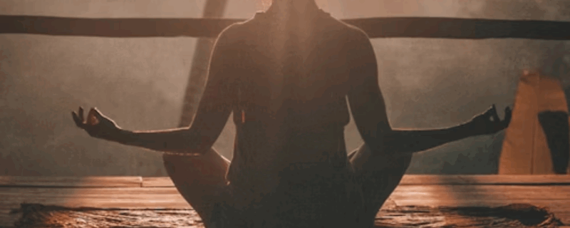 Yoga for Addiction Recovery: How Mind-Body Practices Promote Long-Term Sobriety 1 Woman performing yoga at dusk, looking serene and enlightened as the late afternoon sun casts a warm glow on her.