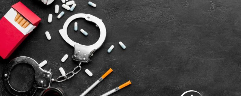 Pills and a syringe laying down