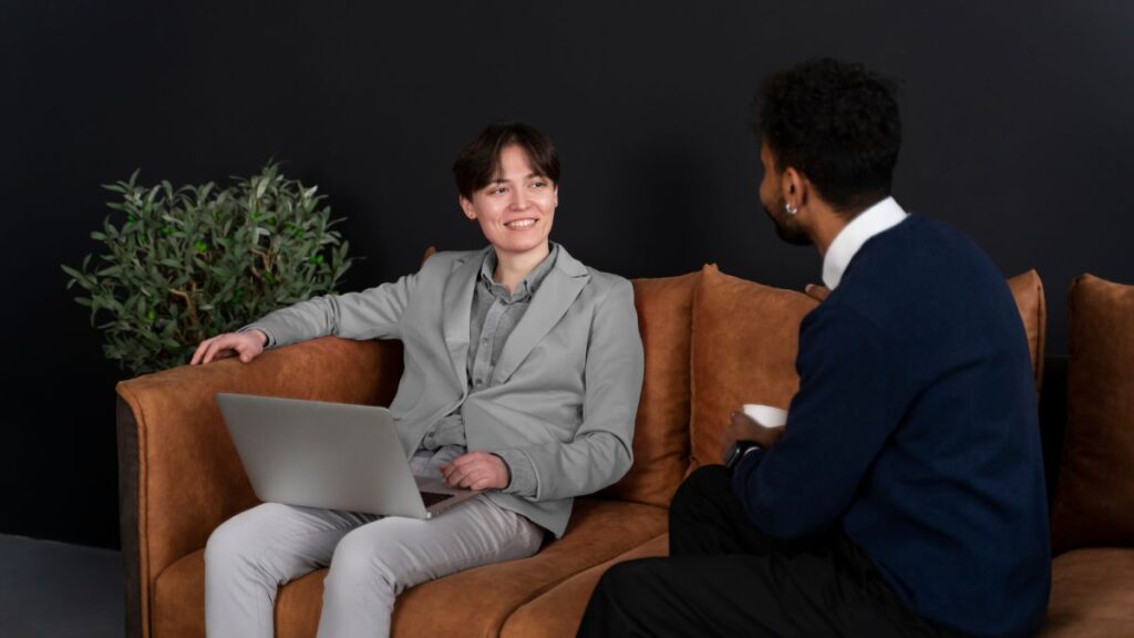The Hidden Crisis: Professionals Hiding Addiction 4 A male patient shares an animated moment with a therapist while discussing his struggles with dependence, reflecting professionals hiding addiction.