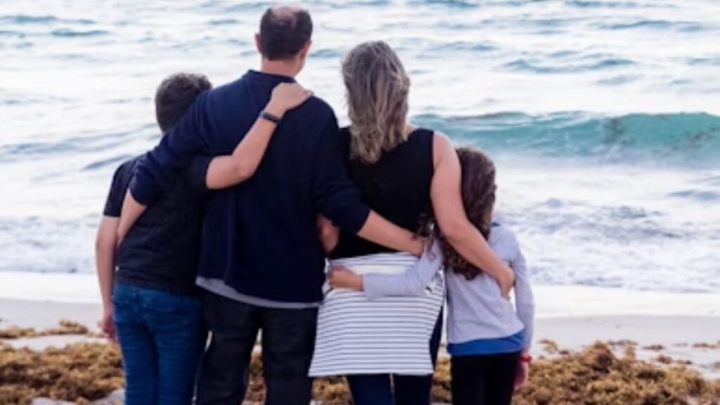 How to Rebuild Trust After Addiction—For Families 2 Rebuild Trust After Addiction: a family stands on the oceanfront amid crashing waves, backs to the camera, holding each other close.