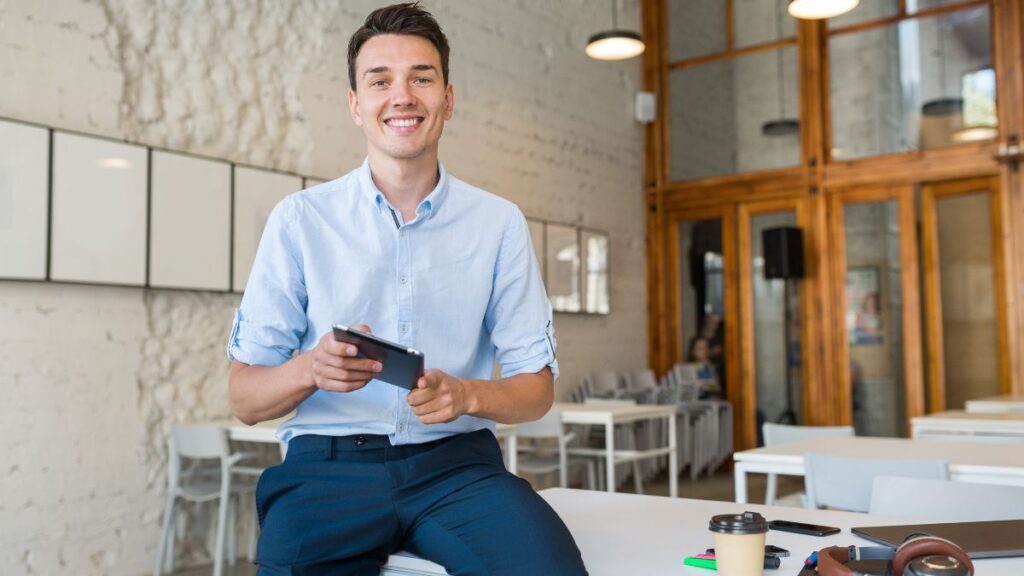 Can You Recover Without Quitting Your Career First? 4 A corporate employee in casual Friday attire looks relaxed and content, smiling confidently at the camera, symbolizing recovery without quitting his career.