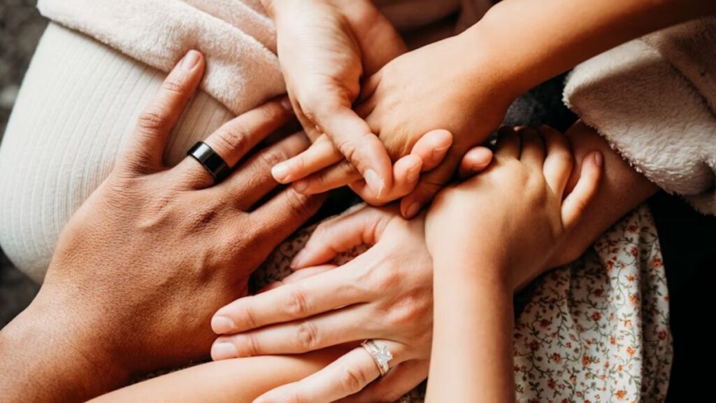 How to Rebuild Trust After Addiction—For Families 4 Rebuild Trust After Addiction: a family holds hands firmly, showing unity; only their hands are visible.