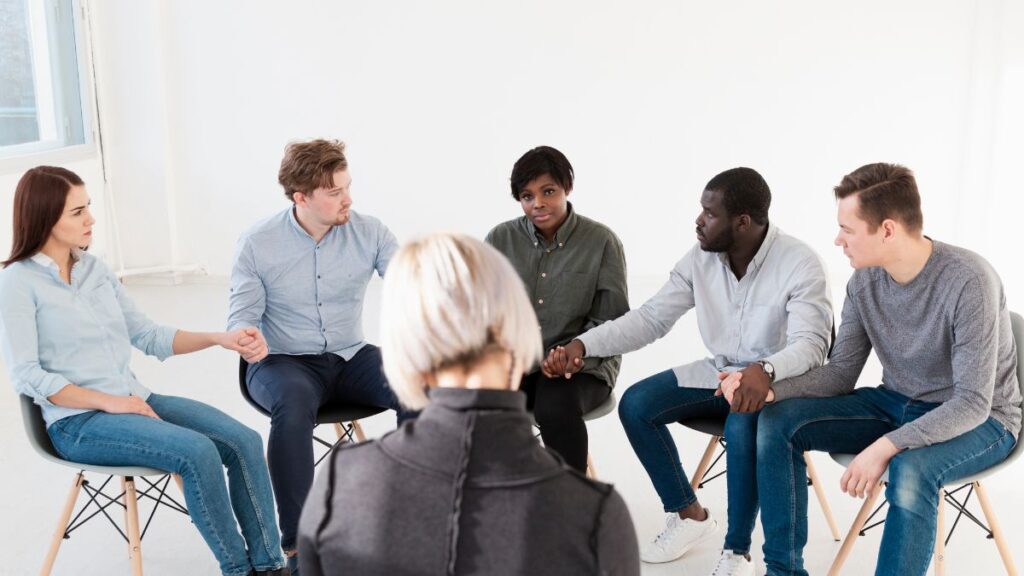 The Role of Therapy in Addiction Treatment 4 In addiction therapy, a group discusses personal issues during a therapy session.