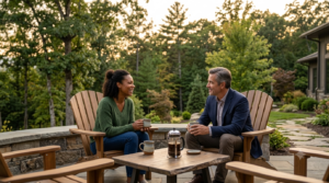 Blog new 9 Two recovering individuals drinking coffee together on an outdoor patio surrounded by trees.